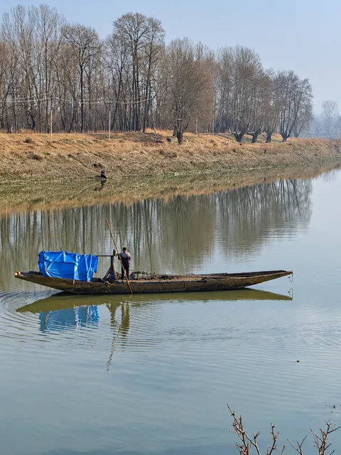 A wooden boat on a still river